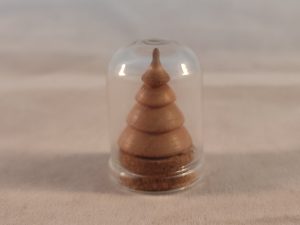 tiny light wood tree in glass dome